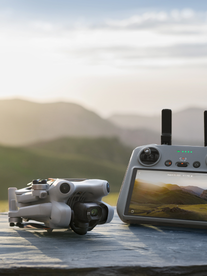 A DJI drone sitting on a table overlooking a great landscape.