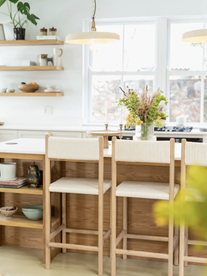 A beautiful minimalist kitchen with cream and oak bar stools from Houthakker.