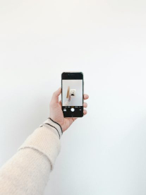 A man's hand with an iphone in.